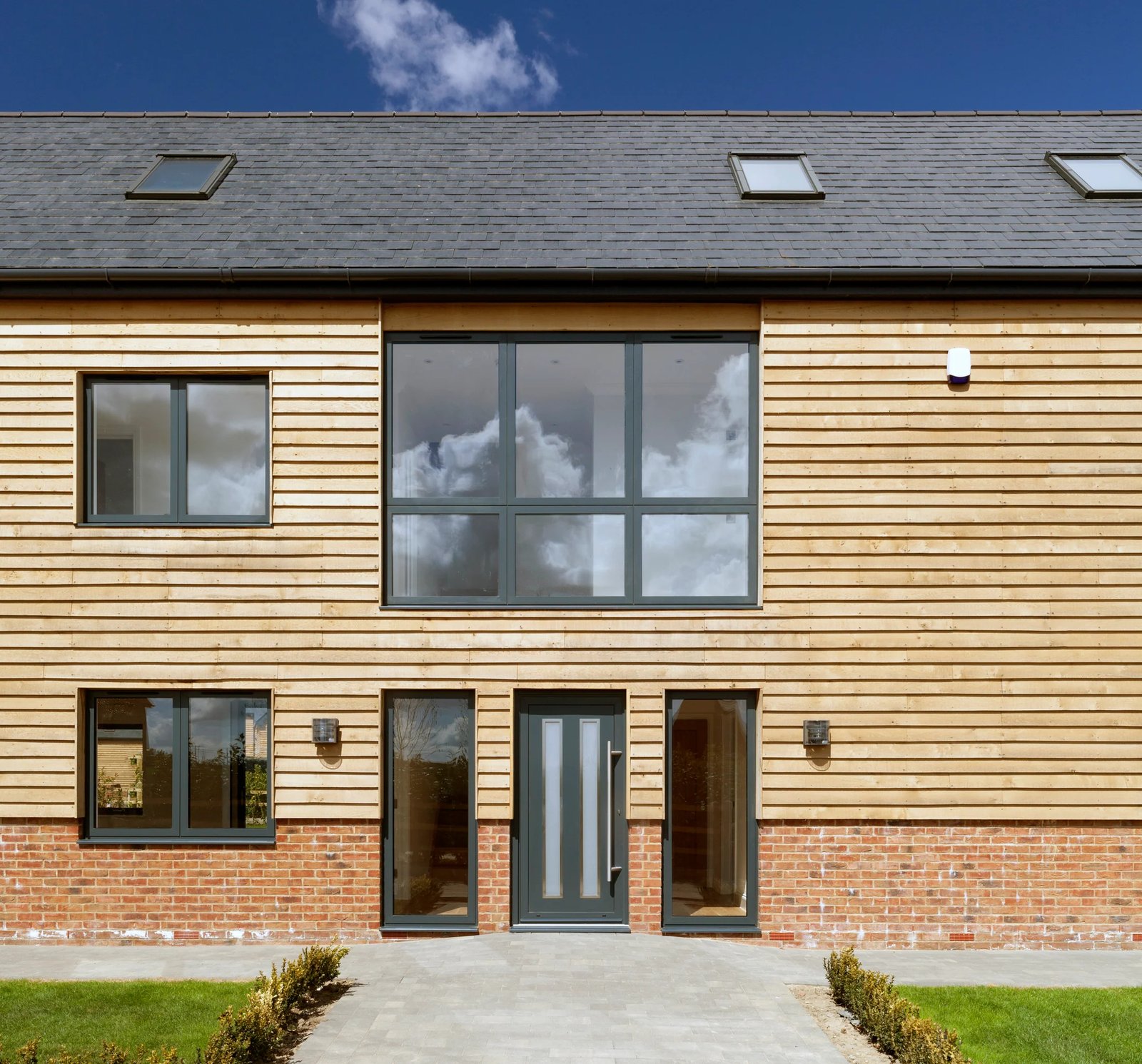 Timber-clad house with grey aluminium windows and doors