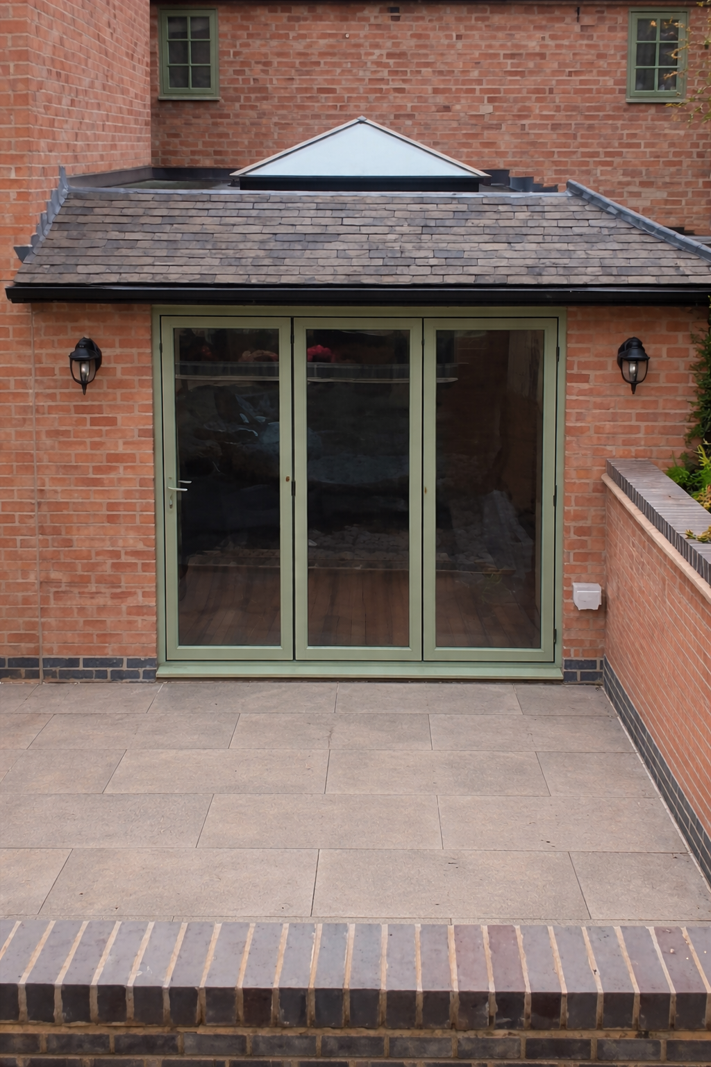 Aluminium bi-folding doors on a brick extension